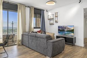 a living room with a couch and a tv at Jerusalem Luxury Apartments by IB Properties in Jerusalem