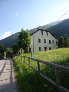 ein Haus auf einem Hügel neben einem Zaun in der Unterkunft Haus Obernig in Mallnitz