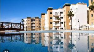 a pool of water in front of some buildings at Residence Al Kawtar in Mohammedia