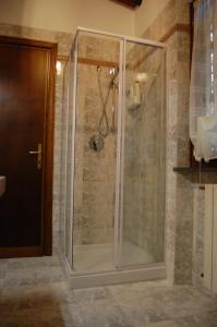 a shower with a glass door in a bathroom at Casa VALGRAZIOSA in Calci