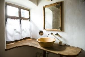 a bathroom with a wooden bowl sink and a mirror at Viscri 125 in Viscri