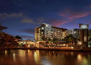 a hotel is lit up at night next to a river at The Gates Hotel South Beach - a Doubletree by Hilton in Miami Beach