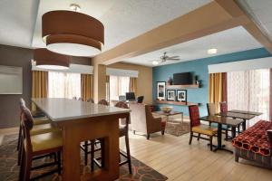 a dining room and living room with a table and chairs at Hampton Inn Phoenix-Chandler in Chandler