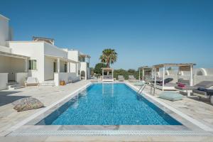 a swimming pool in the middle of a villa at Ambeli Apartments in Perivolos