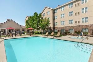 a swimming pool in front of a building at Homewood Suites by Hilton Sacramento/Roseville in Roseville