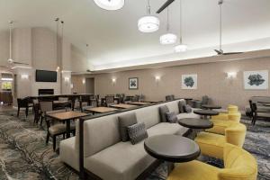 a restaurant with couches and tables and a bar at Homewood Suites by Hilton Sacramento/Roseville in Roseville