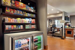 a snack bar with a refrigerator in a restaurant at Hampton Inn Tracy in Tracy