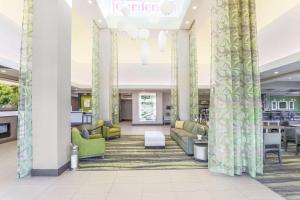 a lobby with couches and chairs in a library at Hilton Garden Inn Ardmore in Ardmore