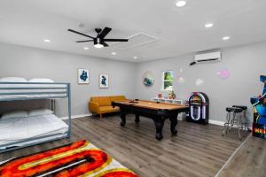 a bedroom with a pool table and a bed at That 70s House -Fun 6 Bedroom W Pool & Game Room in Round Rock +53 photos