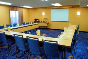 a conference room with tables and chairs and a screen at Courtyard Chicago Deerfield in Deerfield +21 photos