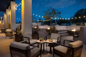 a rooftop patio with tables and chairs at night at Doubletree By Hilton Tucson Downtown Convention Center in Tucson