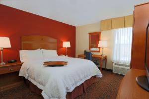 a hotel room with a bed with a tray on it at Hampton Inn St. Louis/Fairview Heights in Fairview Heights