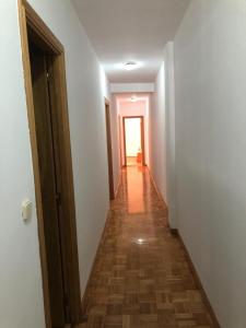 a hallway with white walls and a wooden floor at Apartamento Padrón Centro P5 by UR in Padrón