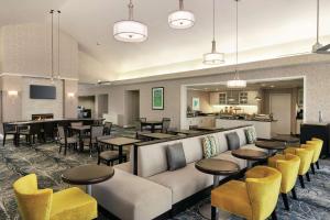a restaurant with tables and chairs and a bar at Homewood Suites by Hilton Corpus Christi in Corpus Christi