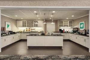 a large kitchen with white cabinets and a large island at Homewood Suites by Hilton Corpus Christi in Corpus Christi