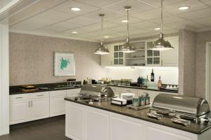 a large kitchen with white cabinets and a counter top at Homewood Suites by Hilton Corpus Christi in Corpus Christi