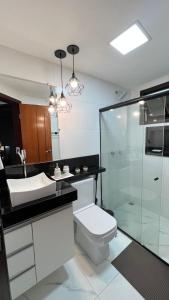 y baño con aseo y ducha acristalada. en Condomínio Golden Dolphin Village, en Porto Seguro