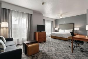 a hotel room with a bed and a desk at Homewood Suites by Hilton Corpus Christi in Corpus Christi +31 photos