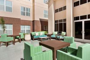 a patio with furniture and tables and windows at Homewood Suites by Hilton Dallas-Arlington in Arlington