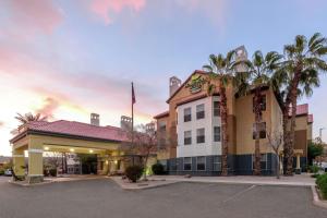 a hotel with palm trees in a parking lot at Homewood Suites by Hilton Phoenix-Chandler in Chandler