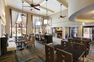 a restaurant with tables and chairs and a bar at Hampton Inn Sedona in Sedona