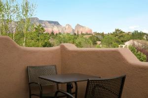 a small table and chairs on a balcony with mountains at Hampton Inn Sedona in Sedona