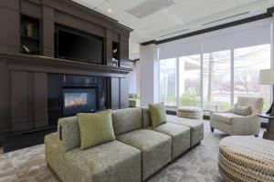 a living room with a couch and a fireplace at Hilton Garden Inn Norman in Norman