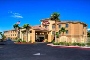 a hotel with an american flag in a parking lot at Hampton Inn & Suites Palmdale in Palmdale