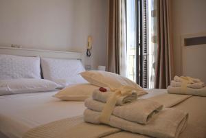 a hotel room with towels on a bed at The Cathedral House in Bari