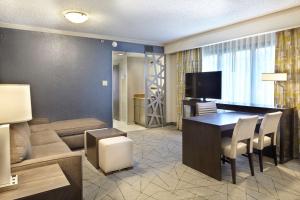 a living room with a table and a living room with a couch at Embassy Suites by Hilton Atlanta Galleria in Atlanta