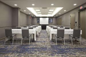 a conference room with tables and chairs and a screen at Embassy Suites by Hilton Atlanta Galleria in Atlanta