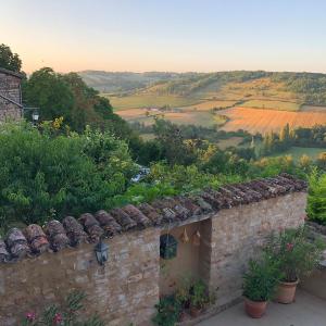a stone house with a view of the countryside at le secret du chat in Cordes-sur-Ciel