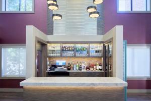 a lobby with a bar with alcohol bottles at DoubleTree by Hilton Atlanta Alpharetta-Windward in Alpharetta
