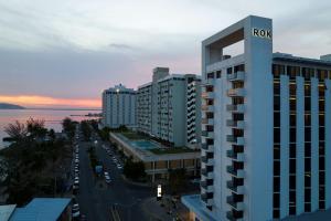 a building with the rico sign on it next to a street at ROK Hotel Kingston Tapestry Collection By Hilton in Kingston