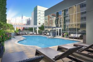 a swimming pool with chairs and a building at DoubleTree by Hilton Hotel Chattanooga Downtown in Chattanooga