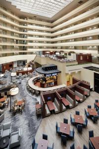 an overhead view of a large building with tables and chairs at Embassy Suites by Hilton Detroit Troy Auburn Hills in Troy