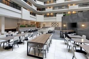 a dining room with tables and chairs in a building at Embassy Suites by Hilton Atlanta Perimeter Center in Atlanta