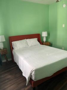 a bed in a bedroom with two nightstands and two lamps at Cosy 3-Bedroom Downtown Walk to Convention Center in Tampa