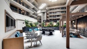 a lobby of an apartment building with tables and chairs at Embassy Suites by Hilton San Rafael Marin County in San Rafael