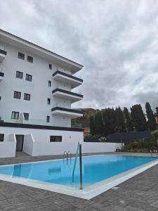 a building with a swimming pool in front of a building at Yuli in Puerto de la Cruz