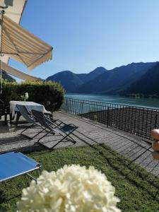 a patio with a table and chairs and a lake at Holiday Apartment Anna 63 Idro in Anfo