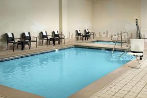 a large swimming pool with chairs and tables at Hilton Garden Inn Yakima Downtown in Yakima