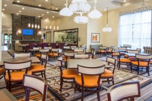 a restaurant with tables and chairs in a lobby at Homewood Suites by Hilton Seattle/Lynnwood in Lynnwood