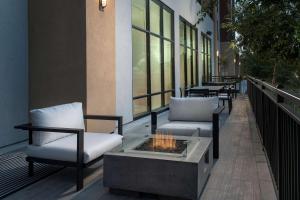 a patio with two chairs and a fire pit at Hilton Garden Inn San Jose Airport in San Jose