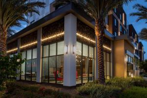einen Außenblick auf ein Gebäude mit Palmen in der Unterkunft Hilton Garden Inn San Jose Airport in San Jose