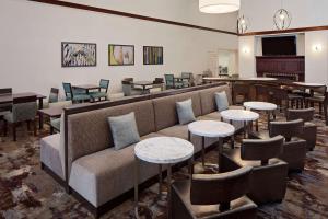 a living room with a couch and tables and chairs at Homewood Suites Nashville/Brentwood in Brentwood