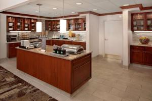 a large kitchen with wooden cabinets and a counter top at Homewood Suites Nashville/Brentwood in Brentwood
