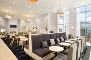 a waiting room with a couch and tables at Homewood Suites By Hilton SLC/Draper in Draper