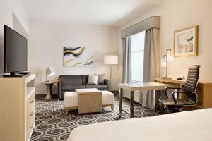 a hotel room with a bed and a living room at Homewood Suites By Hilton SLC/Draper in Draper