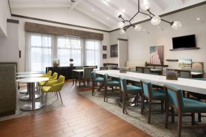 - une salle d'attente avec des tables, des chaises et un piano dans l'établissement Hampton Inn & Suites Houston-Medical Center-NRG Park, à Houston